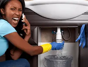 Emergency plumbing repair for a leaking sink drain under a bathroom vanity in Boulder, CO