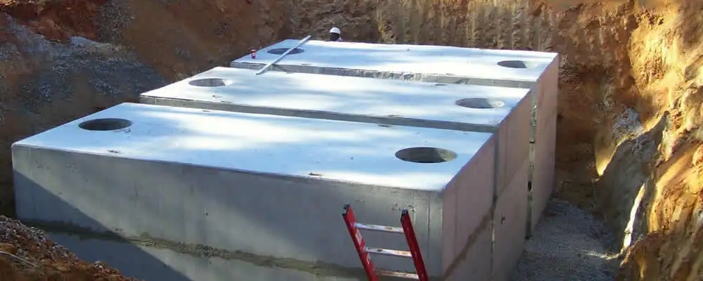 Septic tank installation site with a newly placed concrete tank in Boulder, CO